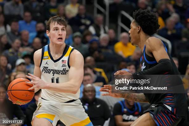 Tyler Kolek of the Marquette Golden Eagles dribbles the ball against Keyondre Young of the DePaul Blue Demons during the first half at Fiserv Forum...