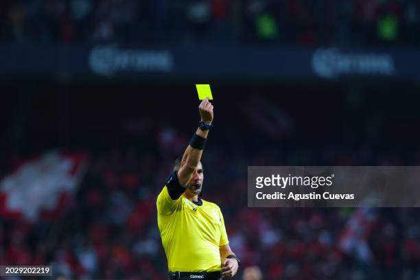 Referee Abraham de Jesus Quirarte shows a yellow card during the 9th round match between Toluca and Santos Laguna as part of Torneo Clausura 2024...