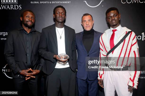 Mamadou Kouassi, Seydou Sarr, Matteo Garrone and Moustapha Fall pose with the Best International Film Award for "Io Capitano" at the 15th Annual...