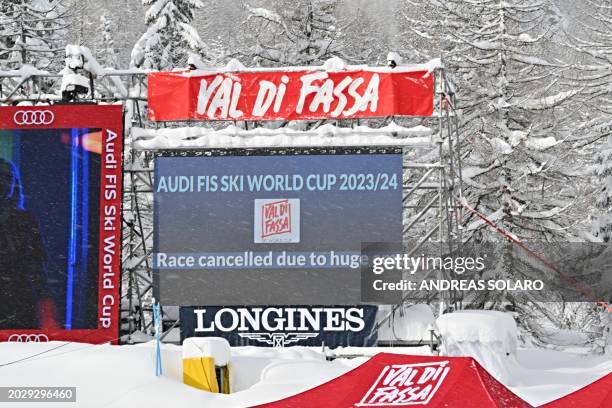 Giant screen in the finish area announce 'Race cancelled due to huge amount of snow during the night' before the Women's Super G event of FIS Alpine...