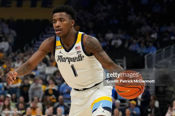 Kam Jones of the Marquette Golden Eagles dribbles the ball during the first half against the DePaul Blue Demons at Fiserv Forum on February 21, 2024...