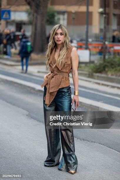 Guest wears brown sleeveless shirt, green pants outside Alberta Ferretti during the Milan Fashion Week - Womenswear Fall/Winter 2024-2025 on February...