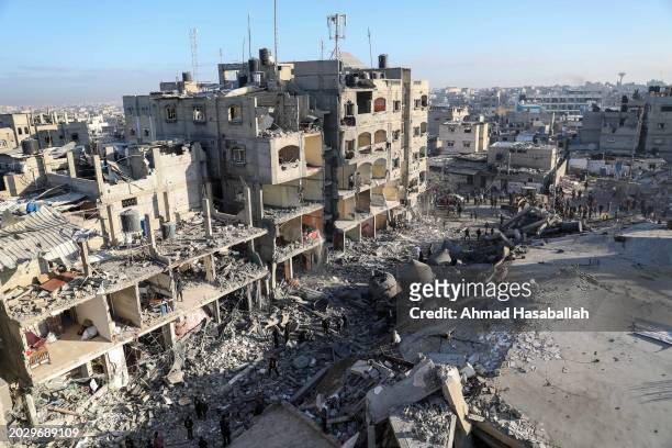 Citizens inspect the effects of the destruction of Al-Farouq Mosque and the buildings destroyed by the Israeli raids on February 22, 2024 in Rafah,...