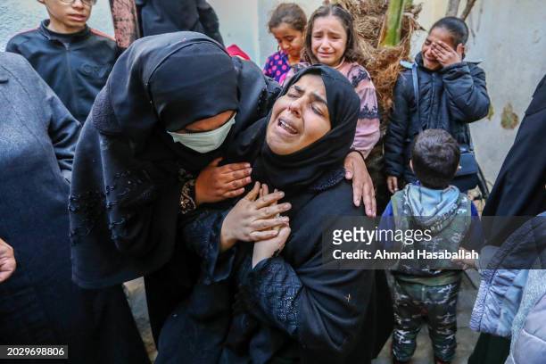 People mourn as they receive the dead bodies of victims of an Israeli strike on February 22, 2024 in Rafah, Gaza. Strikes intensified as Israel...