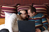 caucasian gay couple bed with laptop