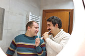 caucasian gay couple brushing their teeth