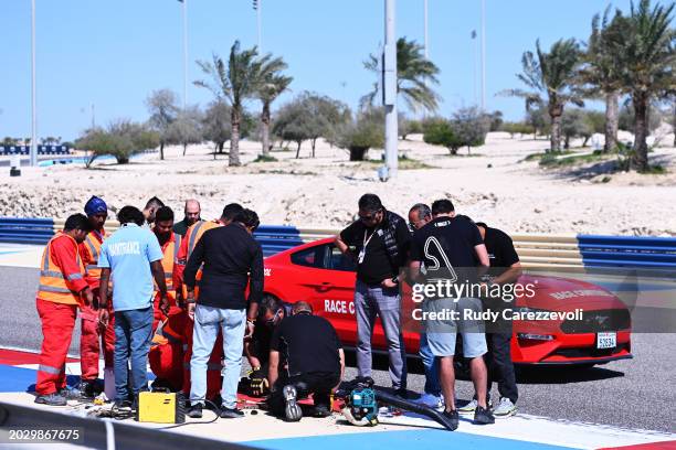 Track workers tend to an issue with the track leading to a cancelled morning session during day two of F1 Testing at Bahrain International Circuit on...