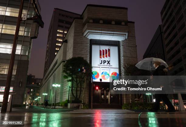 Pedestrian walks past the Tokyo Stock Exchange on February 22, 2024 in Tokyo, Japan. The Nikkei 225 stock index in Japan reached a historic milestone...