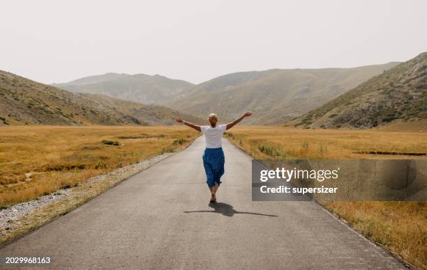 i love to be free - middle age woman bare arms stock pictures, royalty-free photos & images