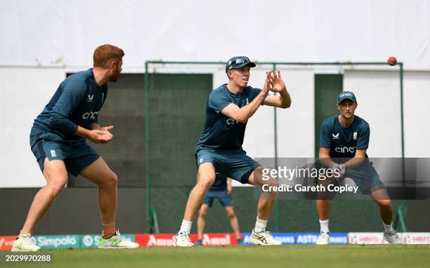 Zak Crawley of England catches in the slips alongside Jonathan Bairstow and Joe Root during a nets session at JSCA International Stadium Complex on...