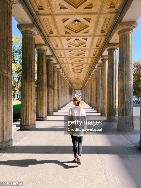 woman walking through kolonnadenhof berlin mitte summer germany - berlin mitte stock pictures, royalty-free photos & images