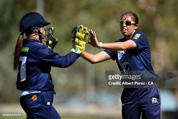 Ella Hayward of Victoria celebrates with team mates during the 2024 National Indigenous Cricket Championships women's match between Queensland and...