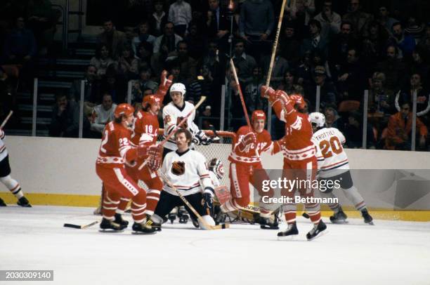 Sergei Kapustin , of the Soviet national team, excitedly throws his arms in the air after he scored a goal in the first period against the NHL...