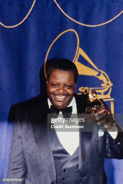 Canadian jazz musician Oscar Peterson posing with his Grammy Award in Los Angeles, February 15th 1979.