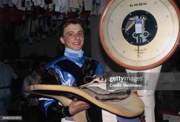 American jockey Ron Franklin standing next to scales in the jockey's room at Gulfstream Park racecourse in Florida, February 19th 1979. He is...