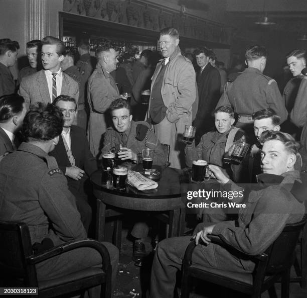 Soldiers enjoying pints of beer in the NAAFI Club's bar at Aldershot Garrison, Hampshire, March 1956.