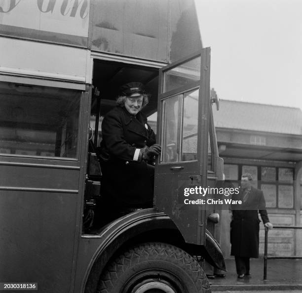 Bus driver Edna Parker seated in the cab of her double-decker bus in Scunthorpe, Lancashire, March 1956. Parker is Scunthorpe's only woman bus driver.