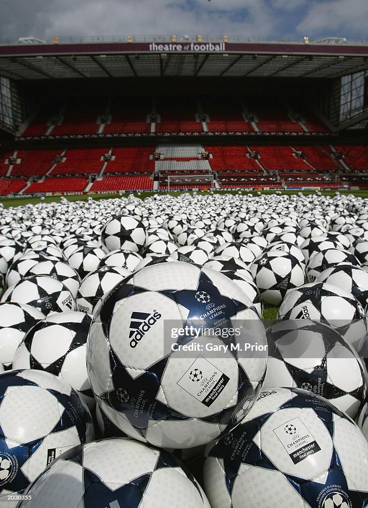 Footballs are arrayed on the pitch at Old Trafford