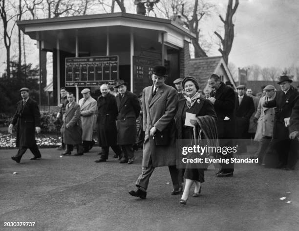 The Queen Mother with racehorse trainer Captain Peter Cazalet at Kempton Park Racecourse, Surrey, January 1st 1957.