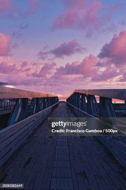 empty footbridge against sky during sunset - francisco gamboa stock pictures, royalty-free photos & images