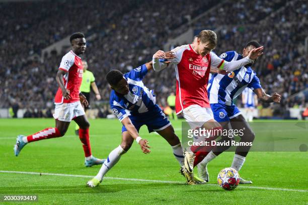 Martin Odegaard of Arsenal competes for the ball with Wendell and Otavio of FC Porto during the UEFA Champions League 2023/24 round of 16 first leg...