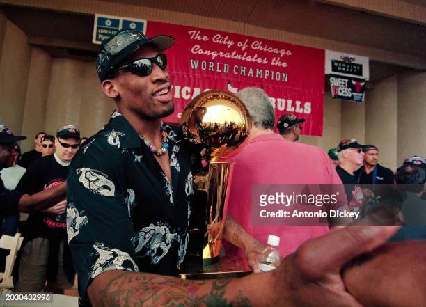 Chicago Bulls forward, Dennis Rodman with the championship trophy at the Celebration Rally held in Grant Park, Chicago, Illinois,15th June 1998.