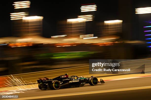 Sparks fly behind Lewis Hamilton of Great Britain driving the Mercedes AMG Petronas F1 Team W15 during day two of F1 Testing at Bahrain International...