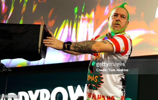 Peter Wright of Scotland plays with a TV camera during his walk on before his 2nd round match with Jim Humphries during day six of the 2023/4 PDC...