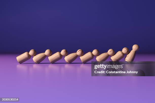 domino effect. toppling wooden figures - system failure stock pictures, royalty-free photos & images
