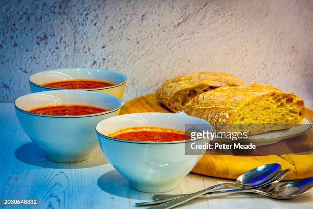 bowls of freshly made soup with bread - soup bowl stock pictures, royalty-free photos & images