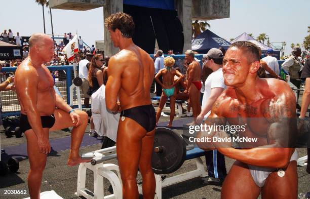 Don Watson practices his poses as bodybuilders warm up before going onstage to compete in the annual Venice Classic bodybuilding competition at...