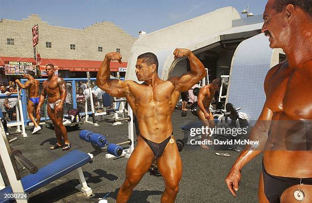 Hugo Rivas poses during his warm-up to compete in the finals of the annual Venice Classic bodybuilding competition at Venice Beach on May 26, 2003 in...