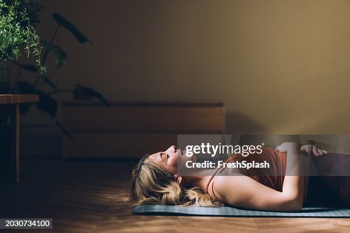 Woman Practicing Yoga, Relaxation Exercise in Serene Indoor Space Woman Practicing Yoga, Relaxation Exercise in Serene Indoor Space