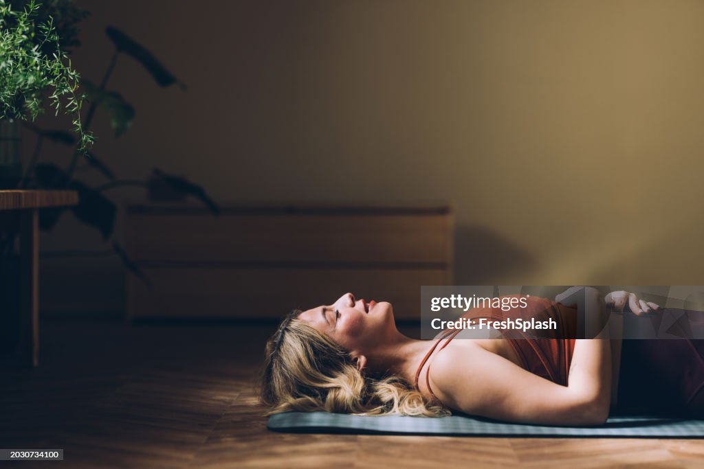 Woman Practicing Yoga, Relaxation Exercise in Serene Indoor Space