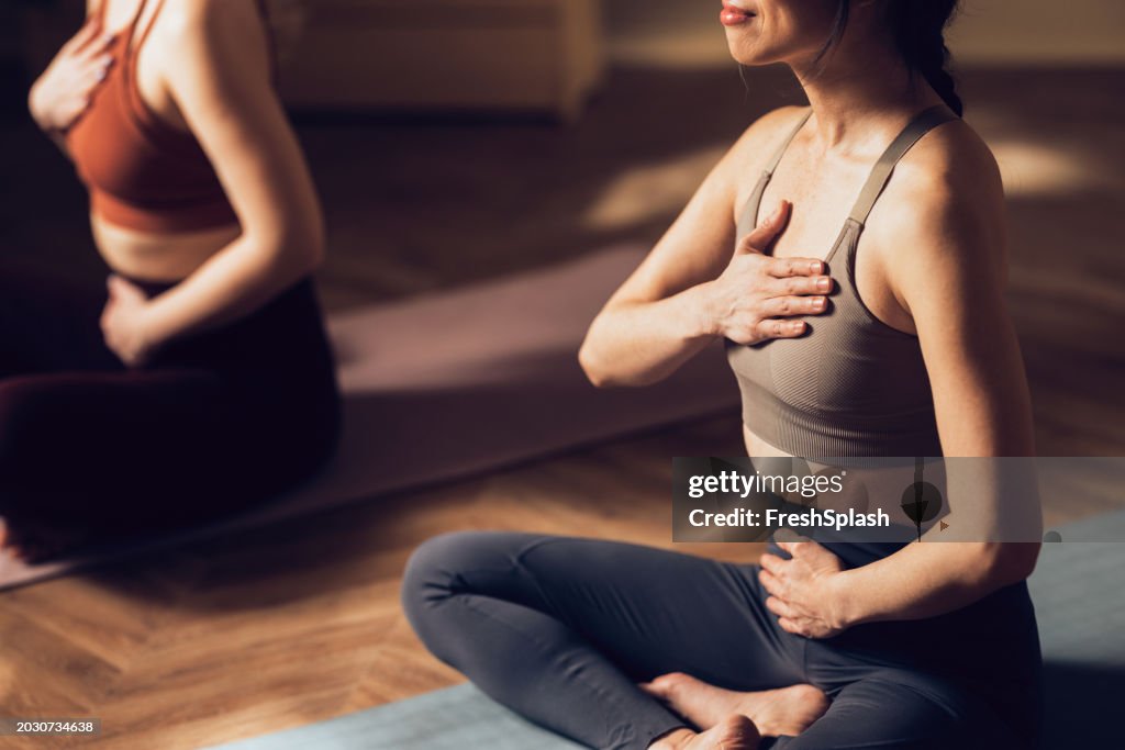 Women Practicing Yoga in a Calm Studio Environment for Wellness