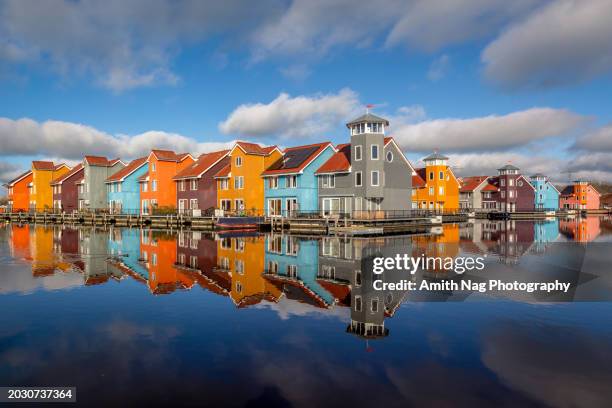 colored houses floating on water - amsterdam sunrise stock pictures, royalty-free photos & images