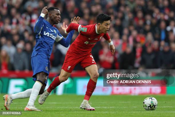 Chelsea's Senegalese striker Nicolas Jackson vies Liverpool's Japanese midfielder Wataru Endo during the English League Cup final football match...