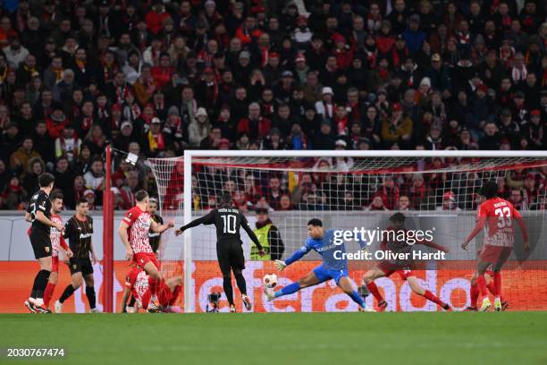 David Costa of RC Lens scores his team's first goal past Noah Atubolu of Sport-Club Freiburg during the UEFA Europa League 2023/24 playoff second leg...