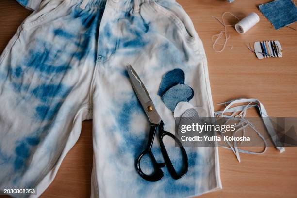 old jeans upcycling idea. crafting with denim, recycling old clothers, hobby, diy activity - ripped jeans stock pictures, royalty-free photos & images