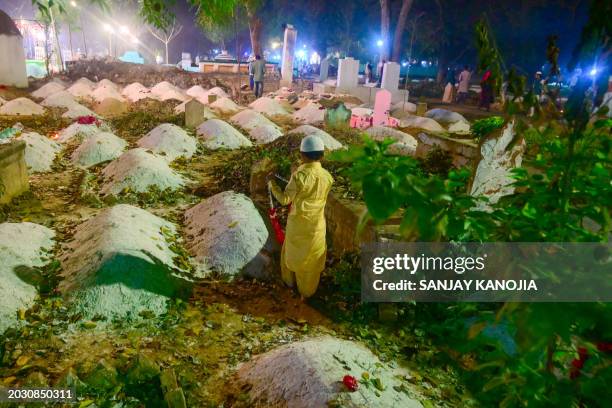 Muslims pray at their relatives' graves on the occasion of Shab-e-Barat in Prayagraj on February 25, 2024.