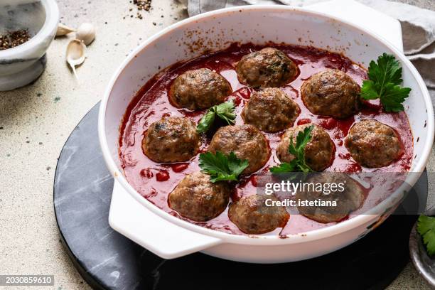 meatballs in tomato sauce, traditional italian polpette, preparing food, close up - plato de carne fotografías e imágenes de stock