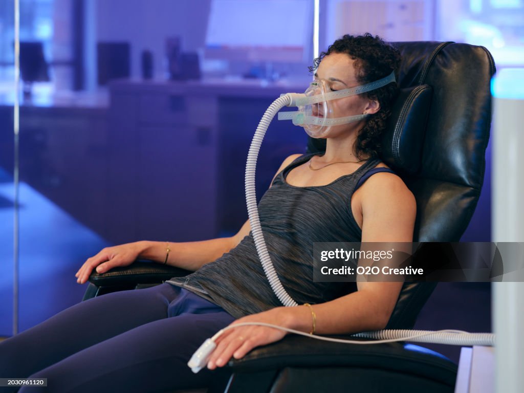 Woman Using Metabolic Oxygen Trainer in a Biohacking Facility