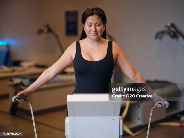 woman using a body composition analysis machine - composition stock pictures, royalty-free photos & images