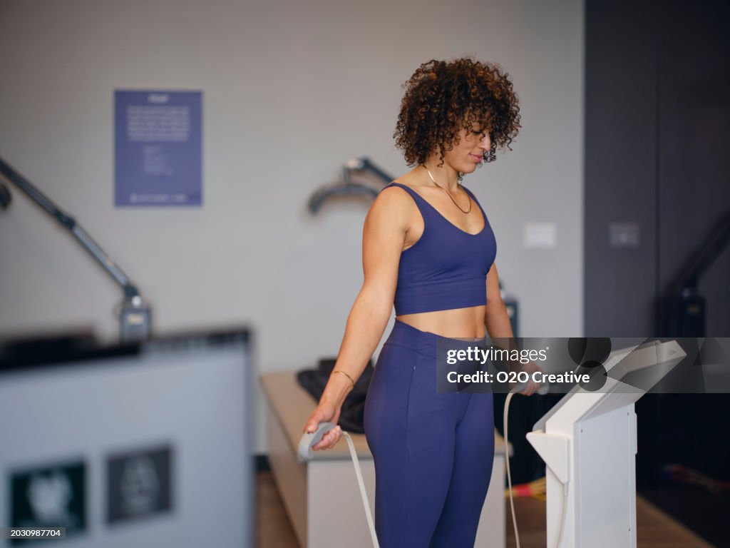 Woman Using a Body Composition Analysis Machine