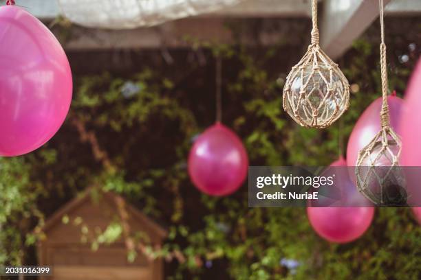 close-up of pink balloons and light decorations hanging in a garden for a party - nuria stock pictures, royalty-free photos & images