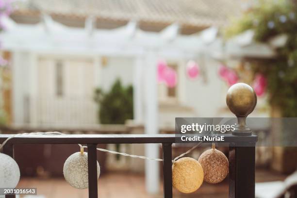 garland of string lights on a garden terrace railing - nuria stock pictures, royalty-free photos & images