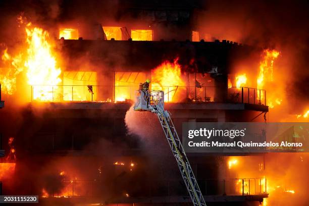 Firefighter works at the scene during the building fire on February 22, 2024 in Valencia, Spain. A large fire has swept through two buildings in the...