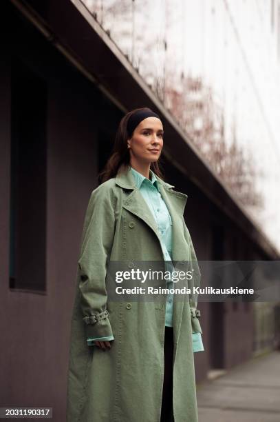 Maria Pombo wears a black headband, a green coat, tights, a turquoise button shirt, and green shorts outside Max Mara during the Milan Fashion Week -...