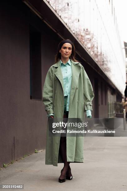 Maria Pombo wears a black headband, a green coat, tights, a turquoise button shirt, and green shorts outside Max Mara during the Milan Fashion Week -...