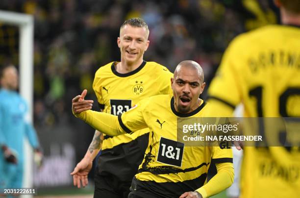 Dortmund's German forward Marco Reus celebrates with Dortmund's Dutch forward Donyell Malen after Malen scored the 1-1 goal during the German first...